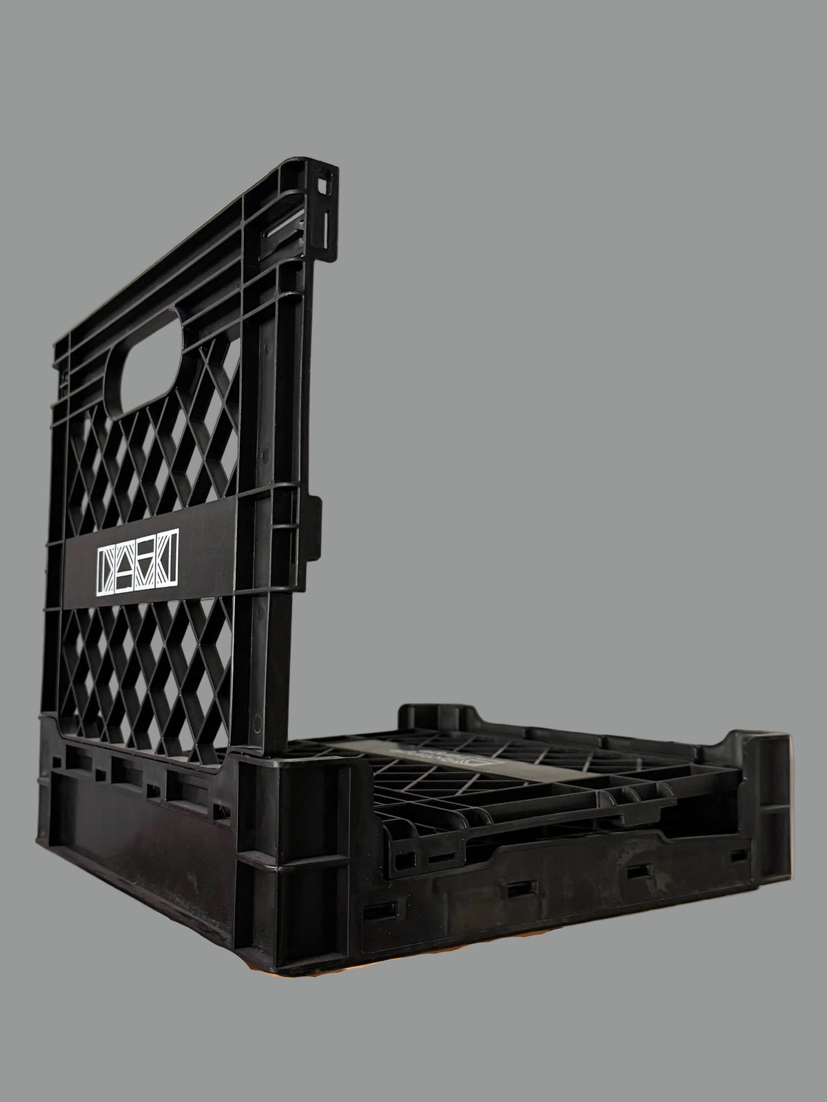 Rectangular Triangle RT milk crate used for storage, featuring sturdy plastic construction and open-top design.