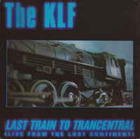 Live performance image of Rectangle Triangle's "Last Train To Trancentral" album cover, featuring vibrant, surreal artwork.