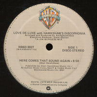 Close-up of the album cover for "Here Comes That Sound Again" by Rectangle Triangle, featuring abstract geometric artwork.