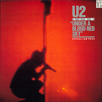 Live "Under A Blood Red Sky" album cover by Rectangle Triangle, featuring a dark red and black abstract design.