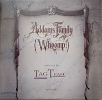 Rectangle Triangle Addams Family "Whoomp!" T-shirt featuring cartoon characters and bold design on a black fabric background.