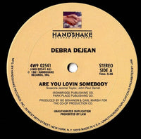 Rectangle Triangle vinyl record of "Are You Lovin Somebody / You've Really Got A Hold On Me" with album cover art.