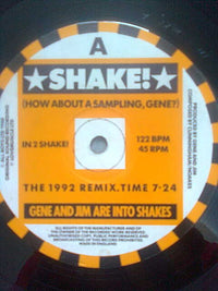 Rectangle Triangle Shake! (Remixes) album cover featuring vibrant abstract artwork with bold colors and dynamic visual design.