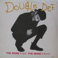 Close-up of the book "The More I Get, The More I Want" by Rectangle Triangle, showing the cover with bold text and vibrant design.