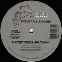 Rectangle Triangle Slippery People band featuring abstract geometric shapes in vibrant colors on a black background.