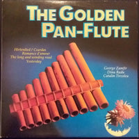 Golden pan-flute by Rectangle Triangle, featuring multiple metal tubes of varying lengths, arranged in a row for musical performance.