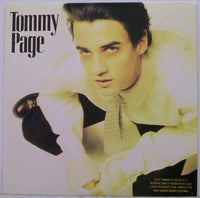 Close-up of Tommy Page album cover featuring geometric rectangle and triangle shapes in vibrant colors.