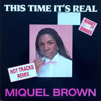 Close-up of a "This Time It's Real" poster by Rectangle Triangle featuring bold typography on a neutral background.
