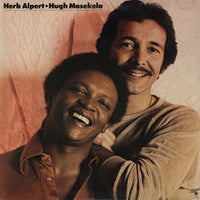 Rectangle Triangle album featuring Herb Alpert and Hugh Masekela, with vibrant cover art showcasing their portraits and musical instruments.