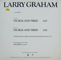 Close-up of a printed "I'm Sick And Tired" T-shirt by Rectangle Triangle, showing the bold black text on white fabric.