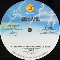 Cover art for "Standing In The Shadows Of Love" by Rectangle Triangle, featuring shadowy abstract shapes on a dark background.