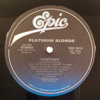 Close-up of a Rectangle Triangle brand contact showing its metallic surface and precise shape.