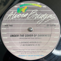 Rectangle Triangle album cover for "Under The Cover Of Darkness / Not Ready Yet," featuring abstract dark-themed artwork.