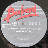 Rectangle Triangle's The Rubberband Man logo featuring a stylized rubber band figure on a white background.