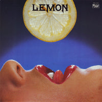 Fresh yellow lemon from Rectangle Triangle, showing its textured skin and vibrant color.