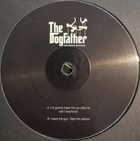 Close-up of a stylish dog tag engraved with "The Dogfather" from Rectangle Triangle, featuring a sleek design on a metal surface.