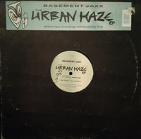 Close-up of The Urban Haze EP album cover by Rectangle Triangle featuring abstract urban-themed artwork.