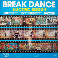 Electric Boogie dance move performed by a dancer in break dance style, showcasing energetic movement and dynamic posture.