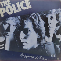 Rectangle Triangle Reggatta De Blanc album cover, featuring abstract geometric artwork with vibrant colors and dynamic shapes.