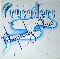 Rectangle Triangle Rhapsody and Blues album cover art featuring abstract geometric shapes in blue tones.