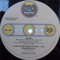 Cover image for "A Spy In The House Of Love" novel by Rectangle Triangle, featuring abstract artwork.