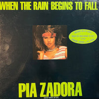 Rectangle Triangle album cover for "When The Rain Begins To Fall" featuring colorful abstract rain-themed artwork.