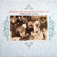 Rectangle Triangle's "The Bad And Lowdown World Of" album cover with abstract geometric shapes in muted tones.