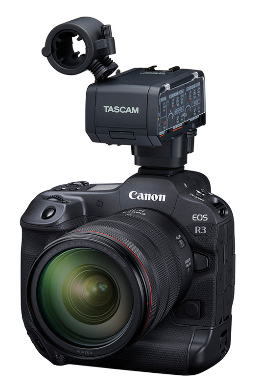 Tascam CA-XLR2d-C XLR microphone adapter connected to Canon camera, used for audio recording with DSLR and video cameras.