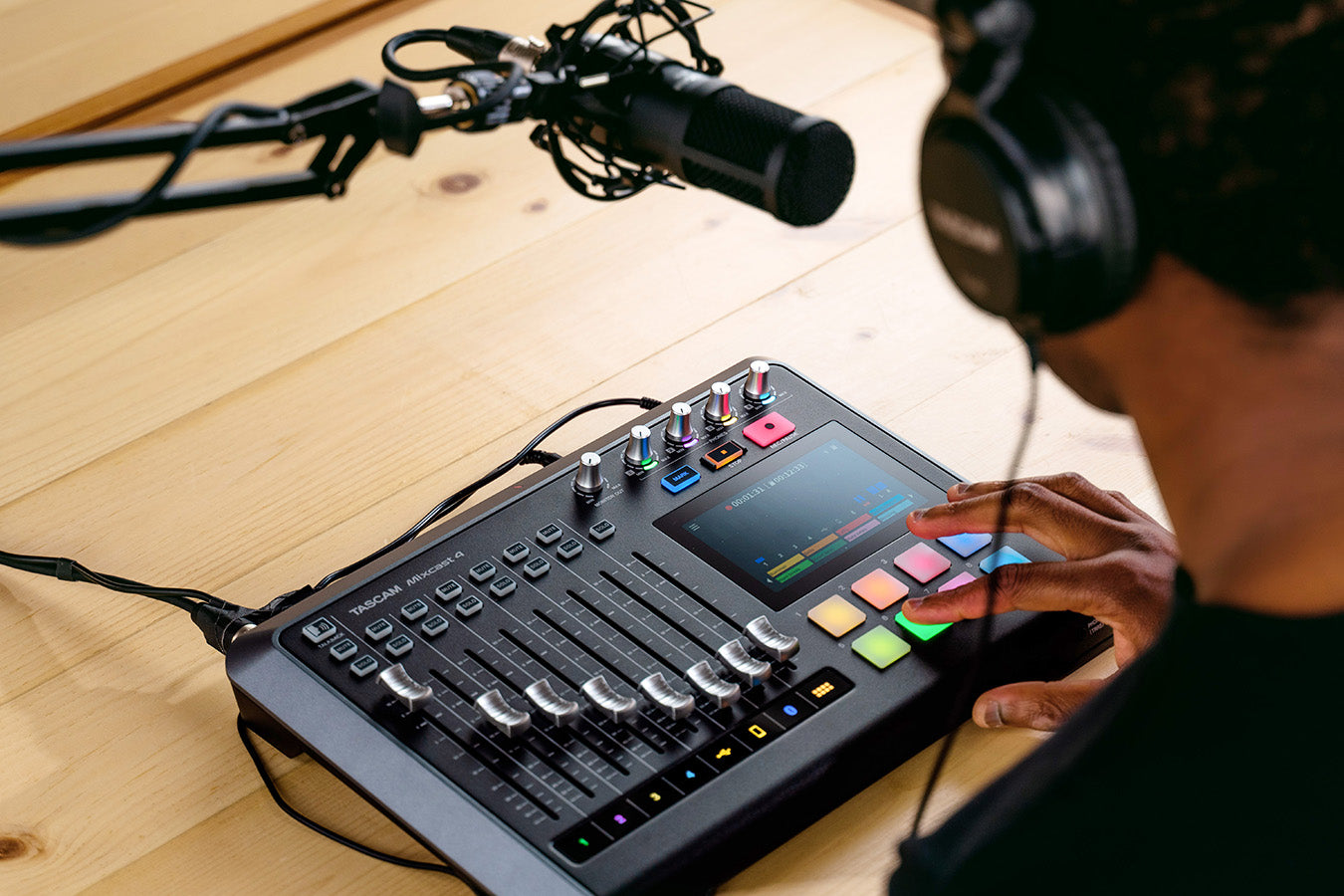 Tascam Mixcast 4 podcast mixer, recorder, and USB audio interface for content creation with multiple input controls and display.