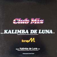Rectangle Triangle Kalimba De Luna (Club Mix) musical instrument with metal tines and wooden body, close-up view.